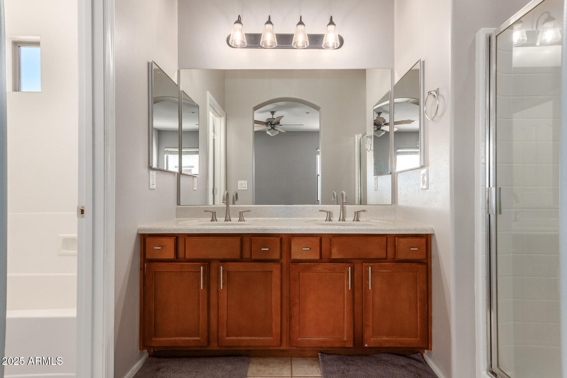 15820 North 74th Drive Peoria, AZ 85382 - Photo 21 of 33 a bathroom with a granite countertop double vanity sink and a mirror