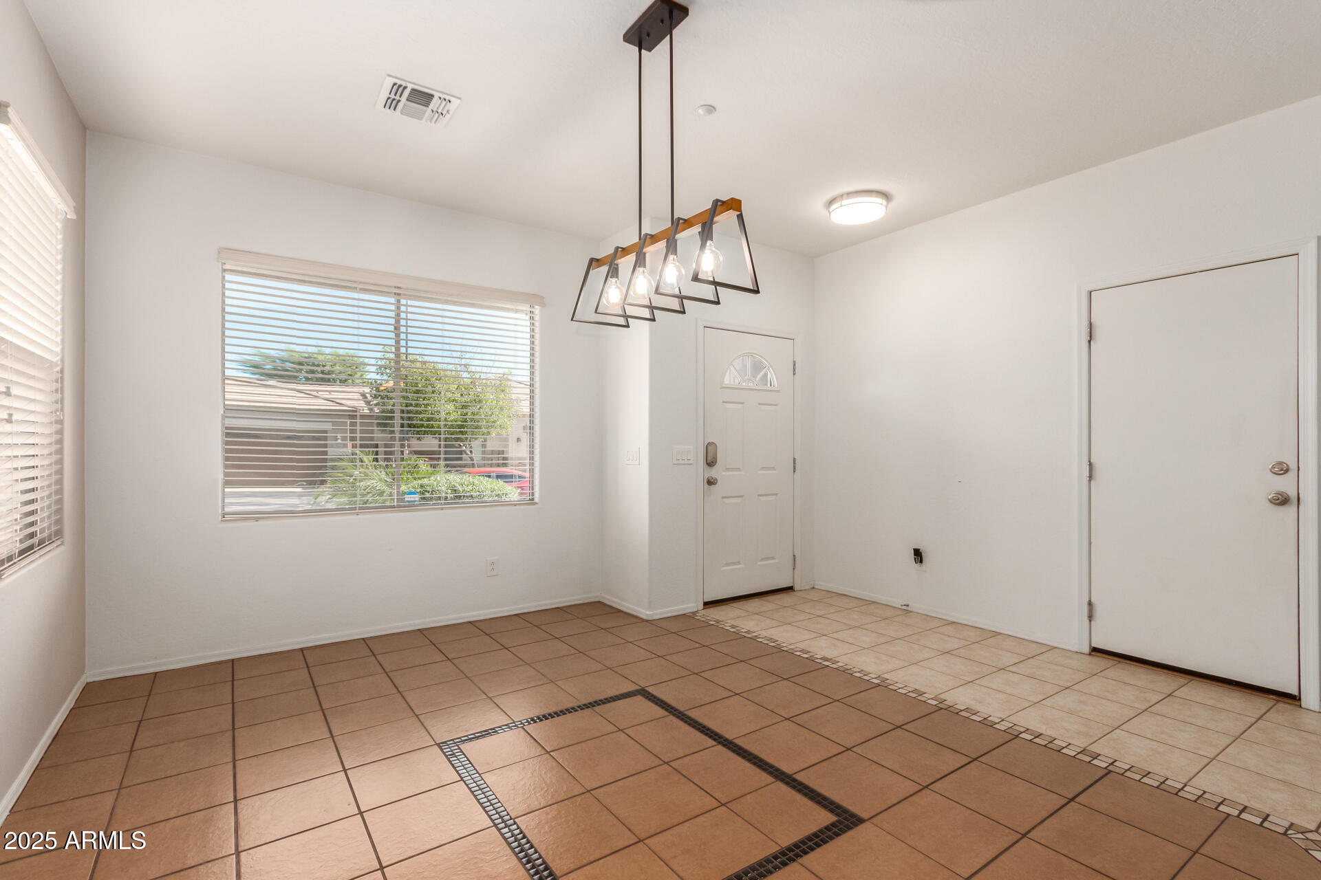 15820 North 74th Drive Peoria, AZ 85382 - Photo 4 of 33 a view of an empty room and window