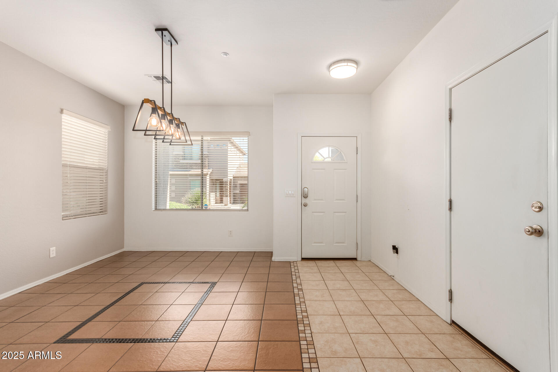 15820 North 74th Drive Peoria, AZ 85382 - Photo 5 of 33 a view of an empty room with window and chandelier fan