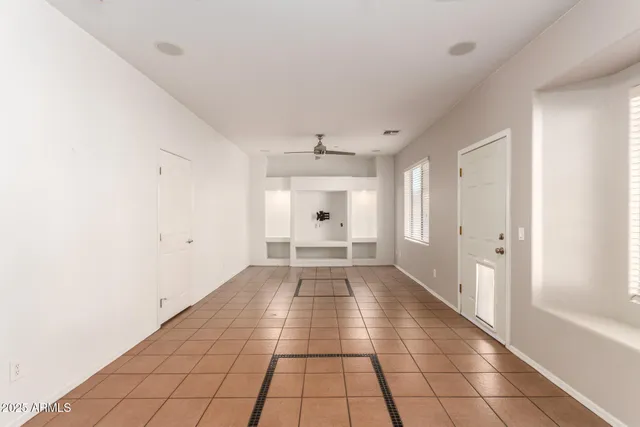 a view of a hallway with wooden floor and a window