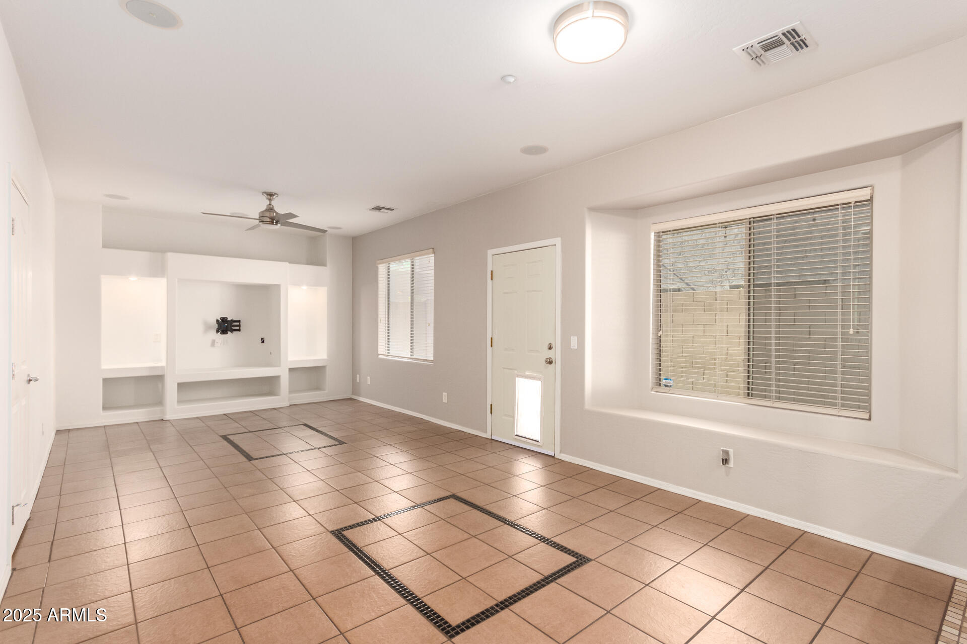 15820 North 74th Drive Peoria, AZ 85382 - Photo 7 of 33 a view of an empty room with a window