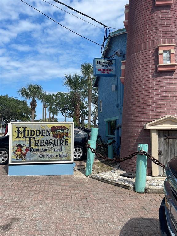 4734 Riverglen Boulevard Ponce Inlet, FL 32127 - Photo 16 of 24 a sign on the side of a building