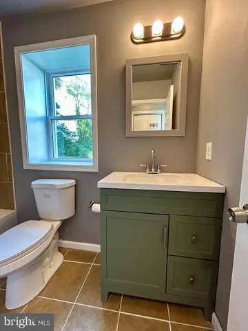 a bathroom with a sink toilet a mirror and shower