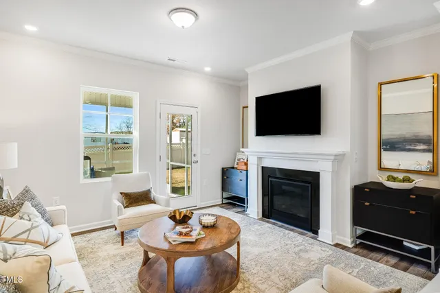 a living room with furniture a fireplace and a flat screen tv