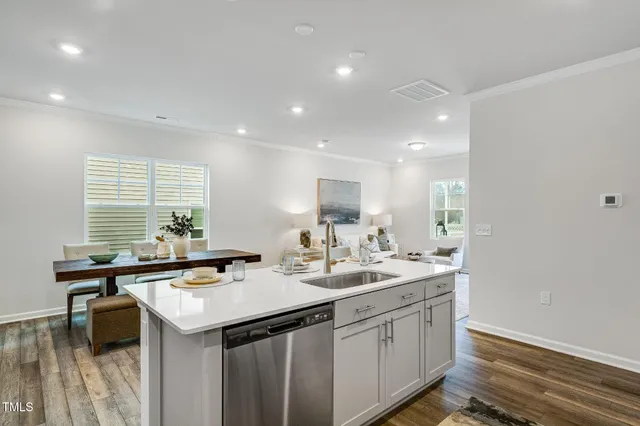 a kitchen with sink stove and microwave