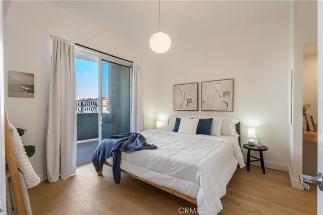 a bedroom with a bed and a painting on the wall