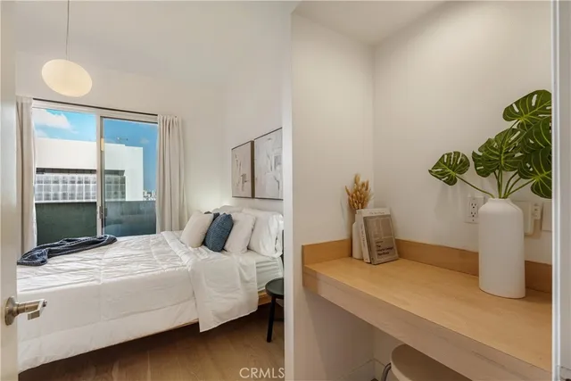 a bedroom with a bed and a potted plant