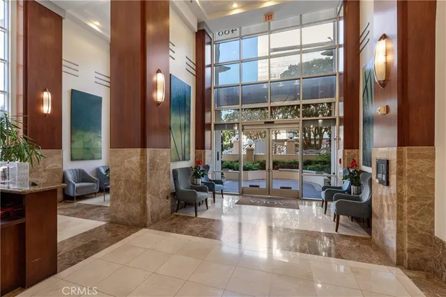 a lobby with furniture and floor to ceiling window