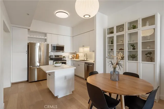 a kitchen with refrigerator and microwave