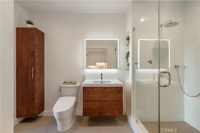 a bathroom with a toilet a sink and shower