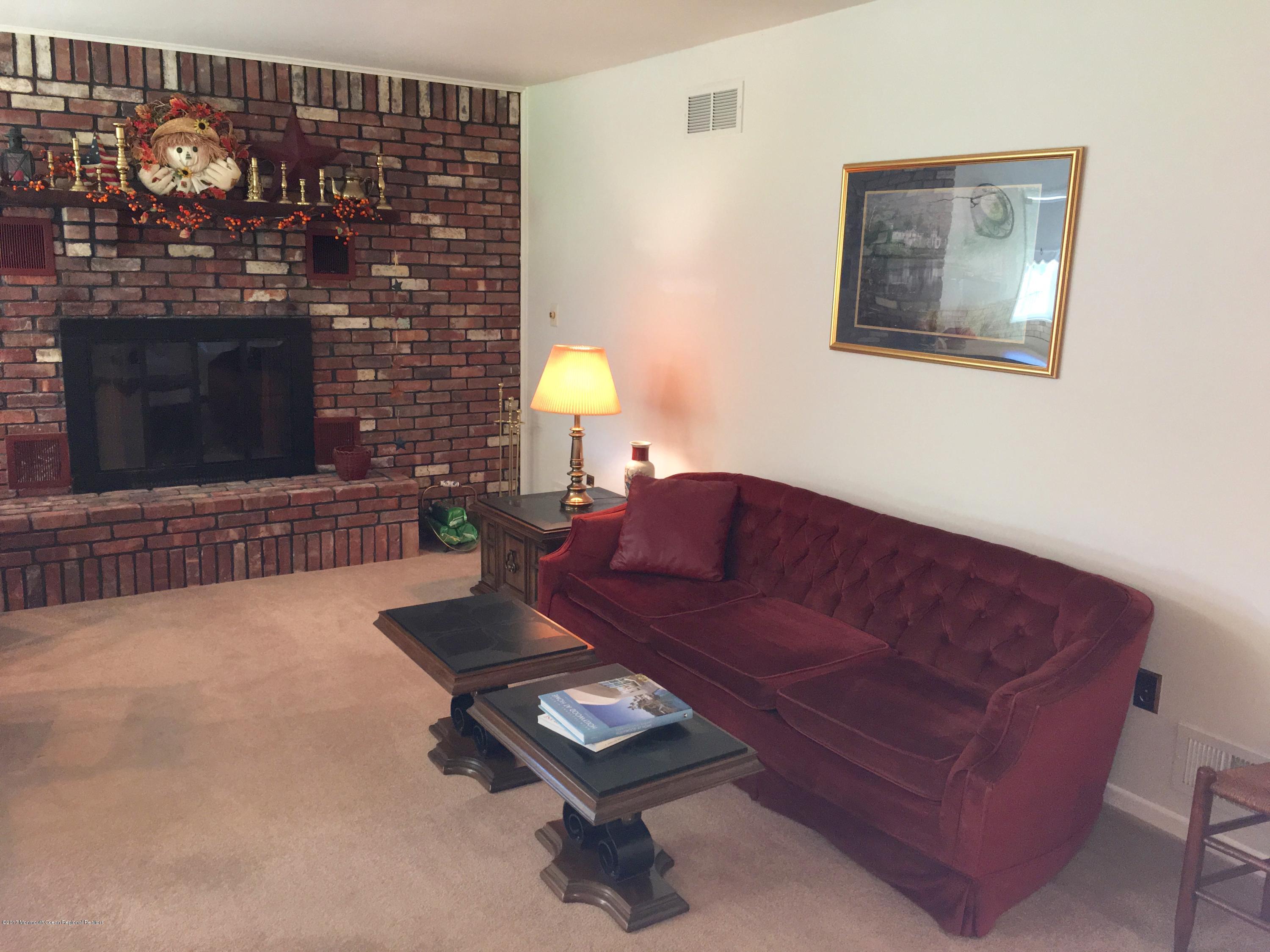 10 Fenimore Road Freehold, NJ 07728 - Photo 11 of 36 a living room with furniture and a fireplace