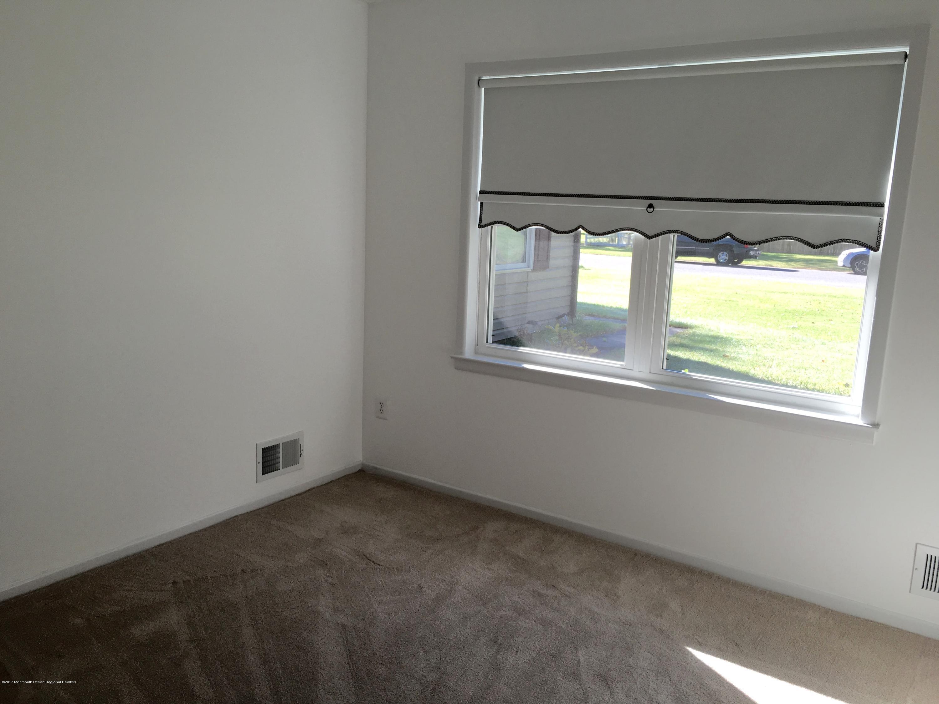 10 Fenimore Road Freehold, NJ 07728 - Photo 16 of 36 an empty room with windows