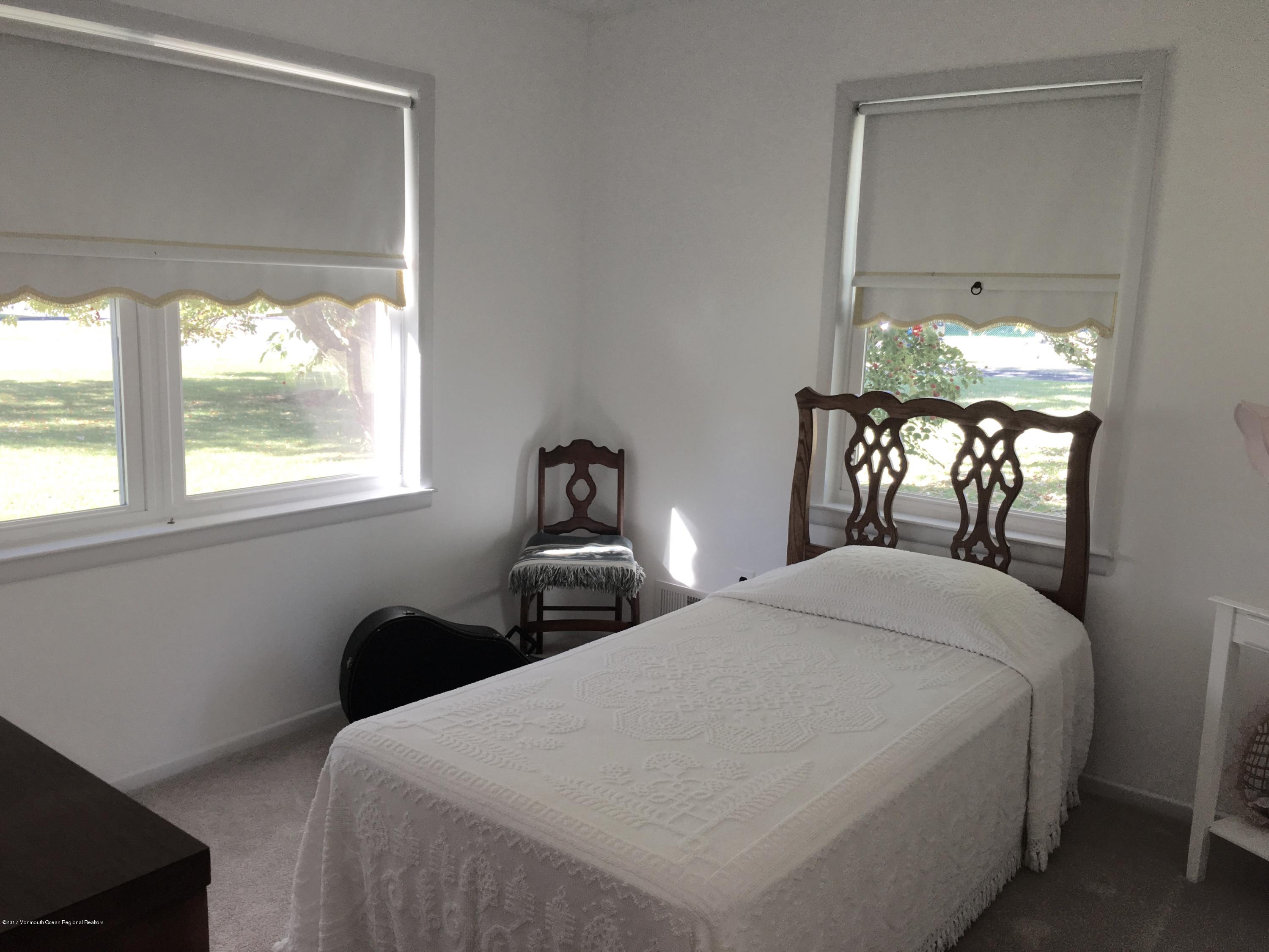 10 Fenimore Road Freehold, NJ 07728 - Photo 17 of 36 a bedroom with a bed and a window