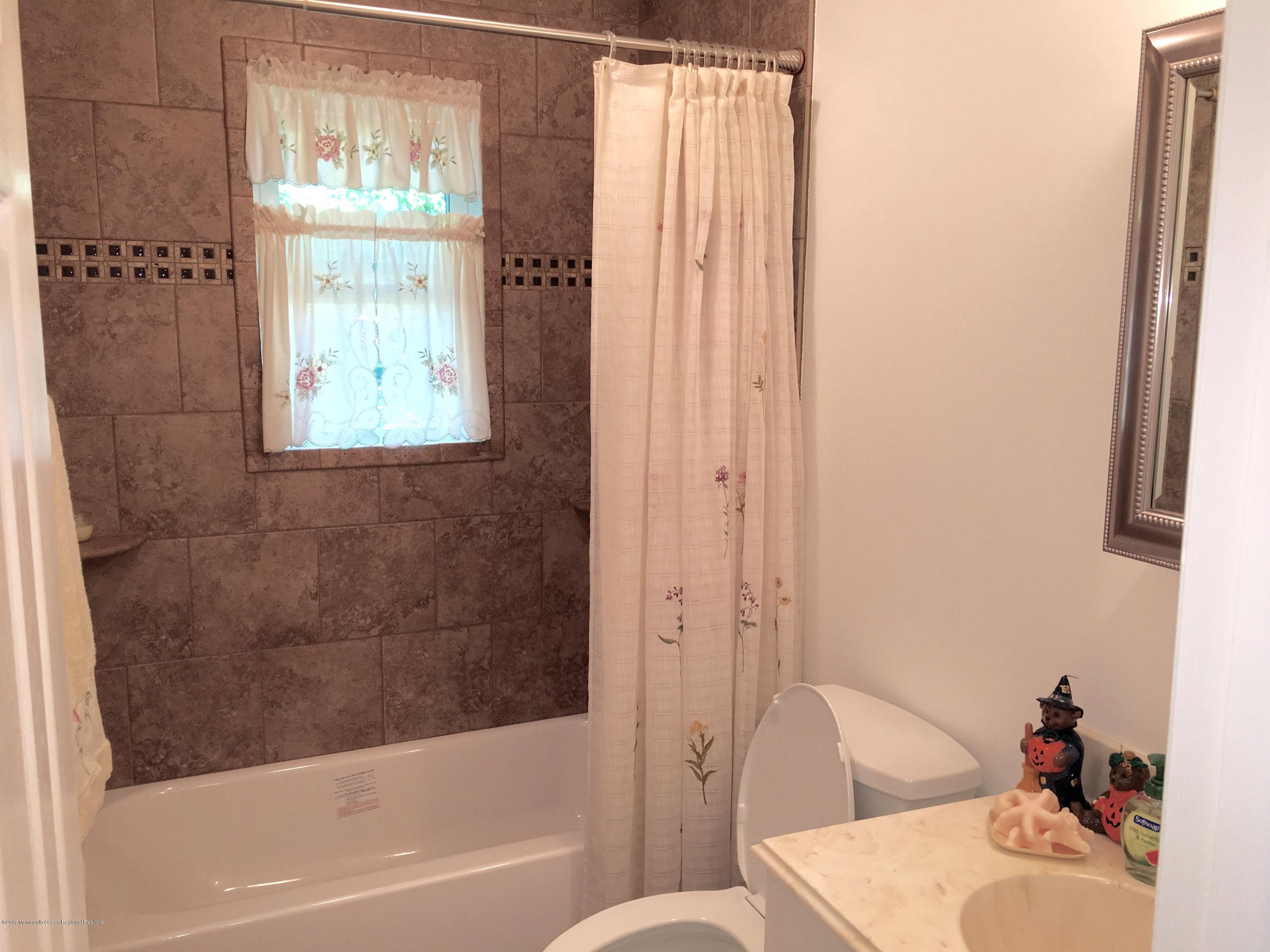 10 Fenimore Road Freehold, NJ 07728 - Photo 18 of 36 a bathroom with a sink toilet and shower
