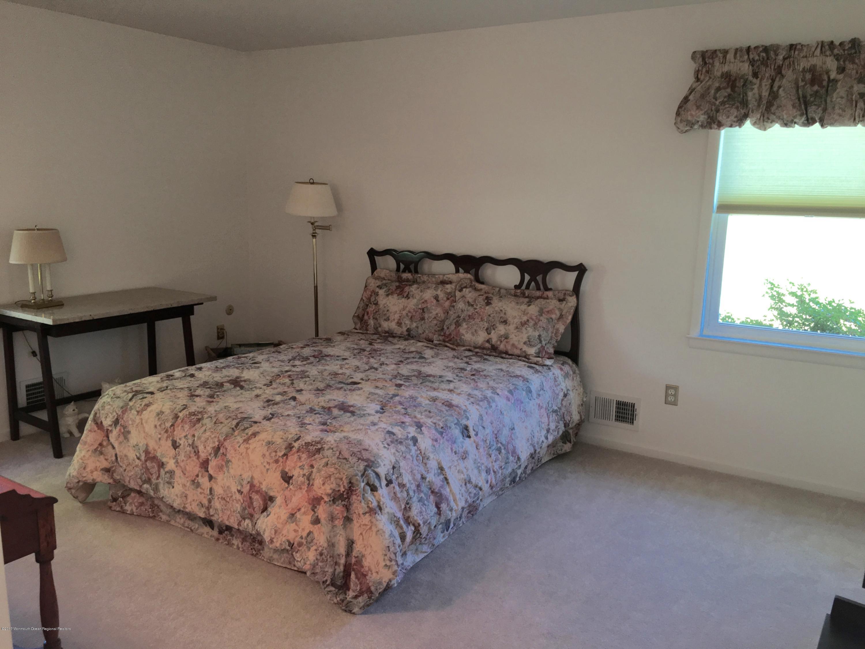 10 Fenimore Road Freehold, NJ 07728 - Photo 21 of 36 a large bed sitting in a bedroom next to a window