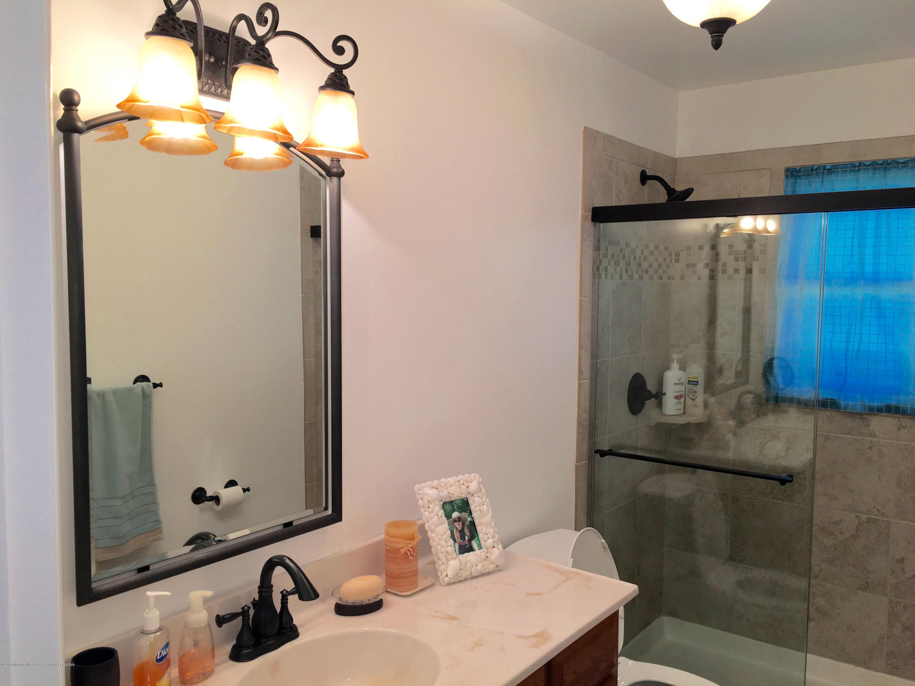 10 Fenimore Road Freehold, NJ 07728 - Photo 23 of 36 a bathroom with a sink and mirror