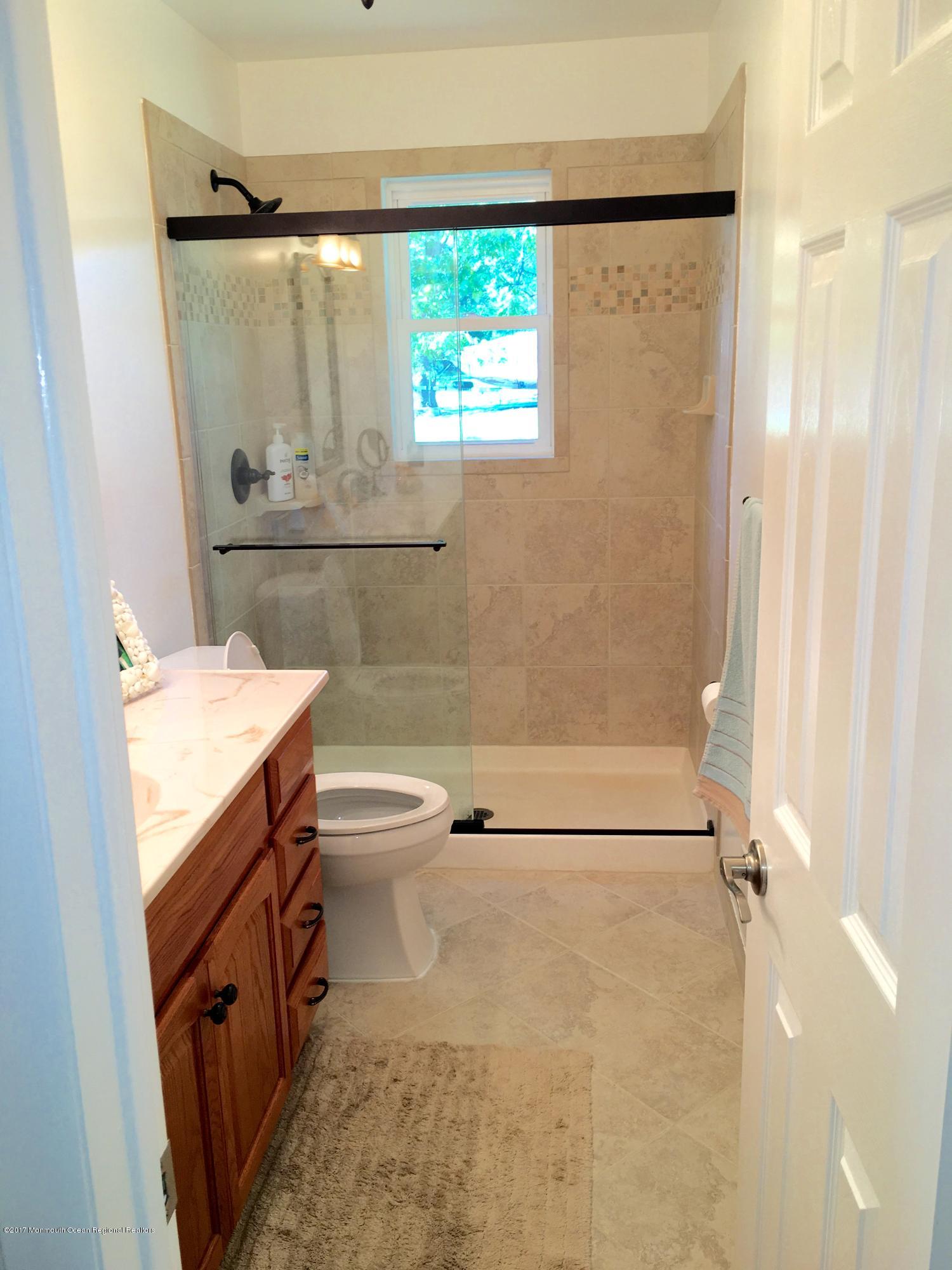 10 Fenimore Road Freehold, NJ 07728 - Photo 24 of 36 a bathroom with a granite countertop sink toilet and shower