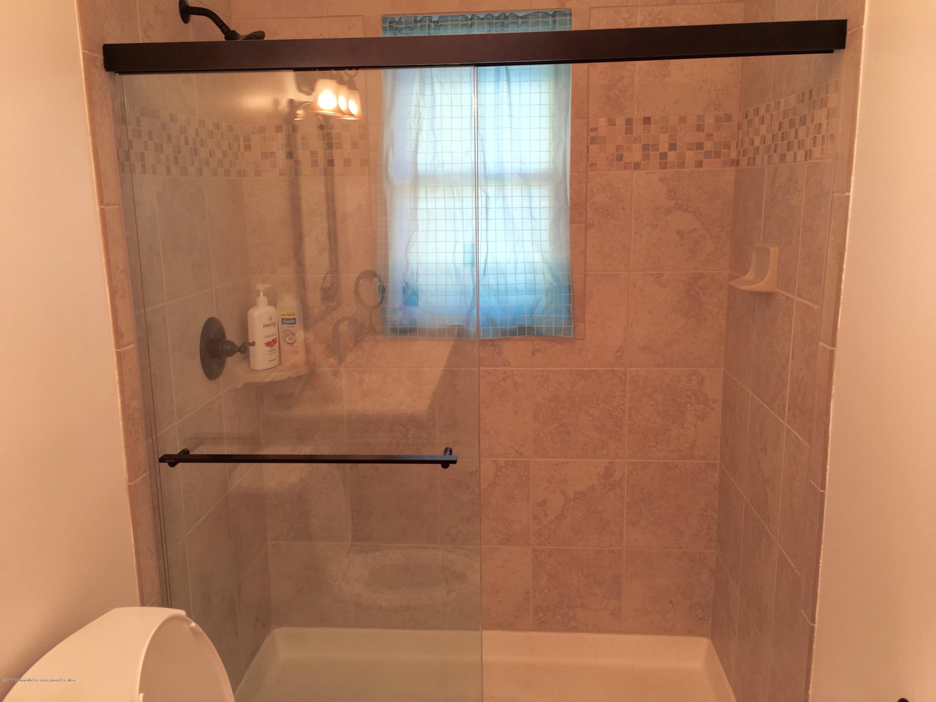 10 Fenimore Road Freehold, NJ 07728 - Photo 25 of 36 a bathroom with a window and a shower