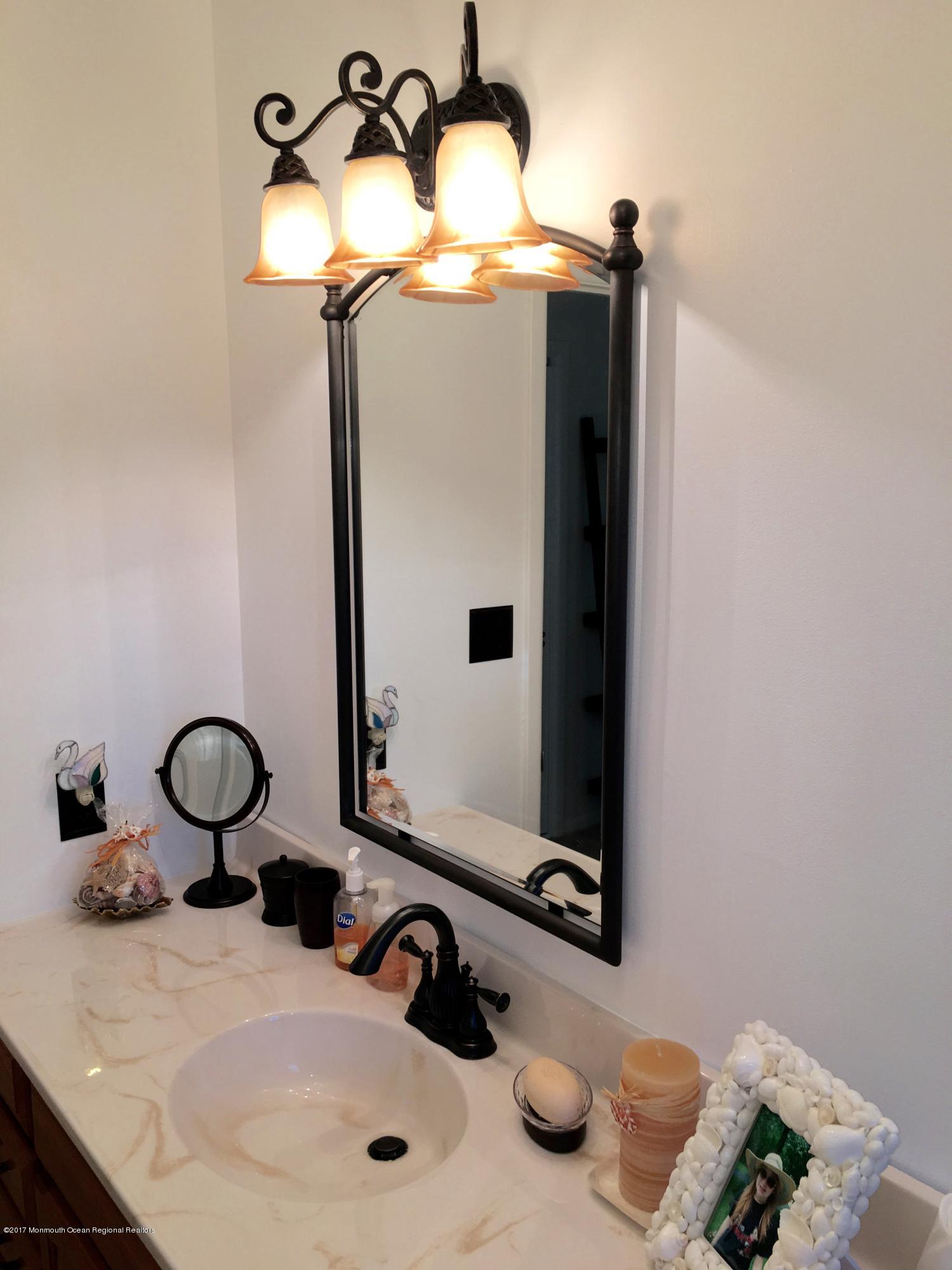 10 Fenimore Road Freehold, NJ 07728 - Photo 26 of 36 a bathroom with a sink and a mirror