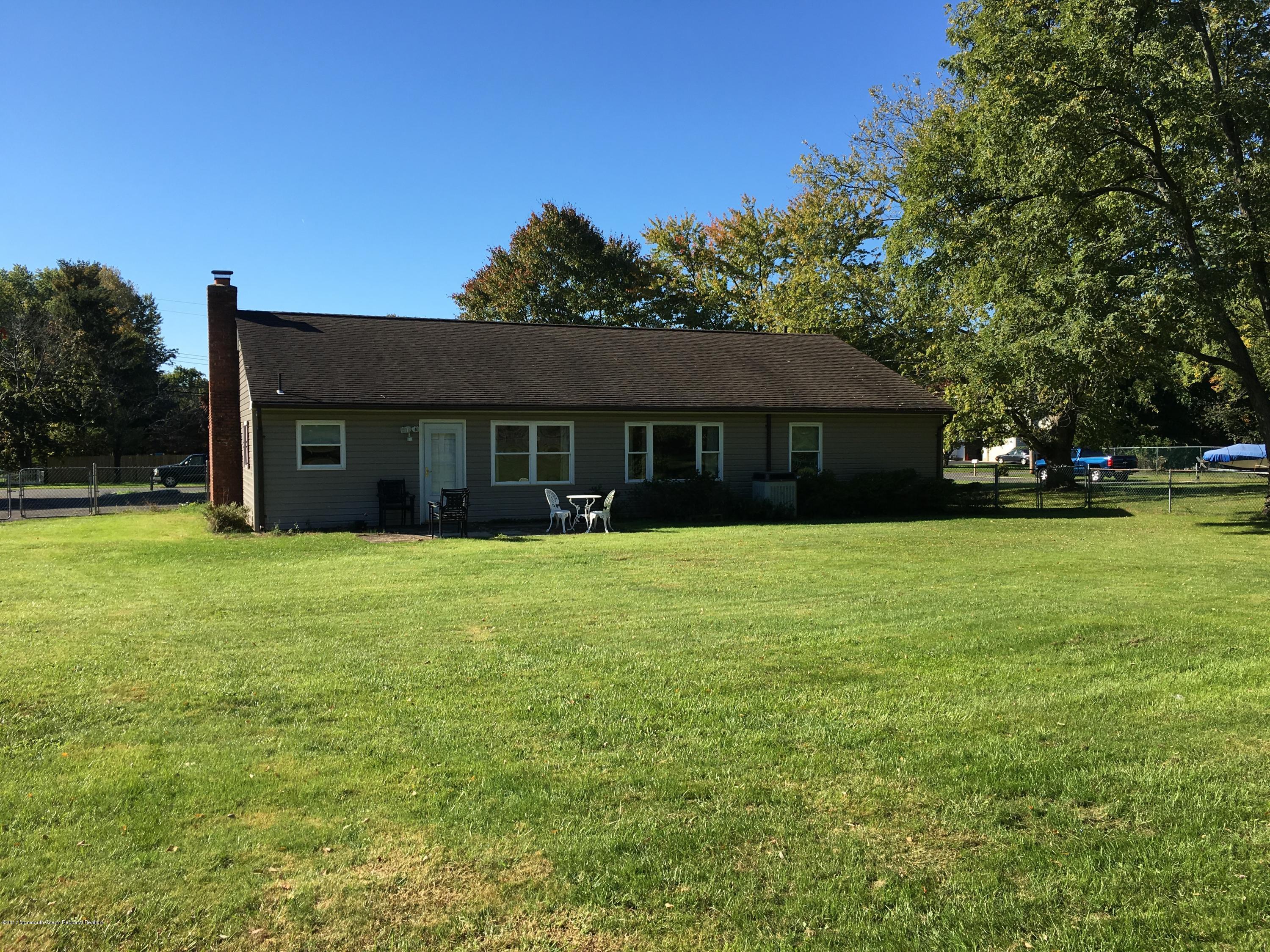 10 Fenimore Road Freehold, NJ 07728 - Photo 33 of 36 a front view of a house with garden