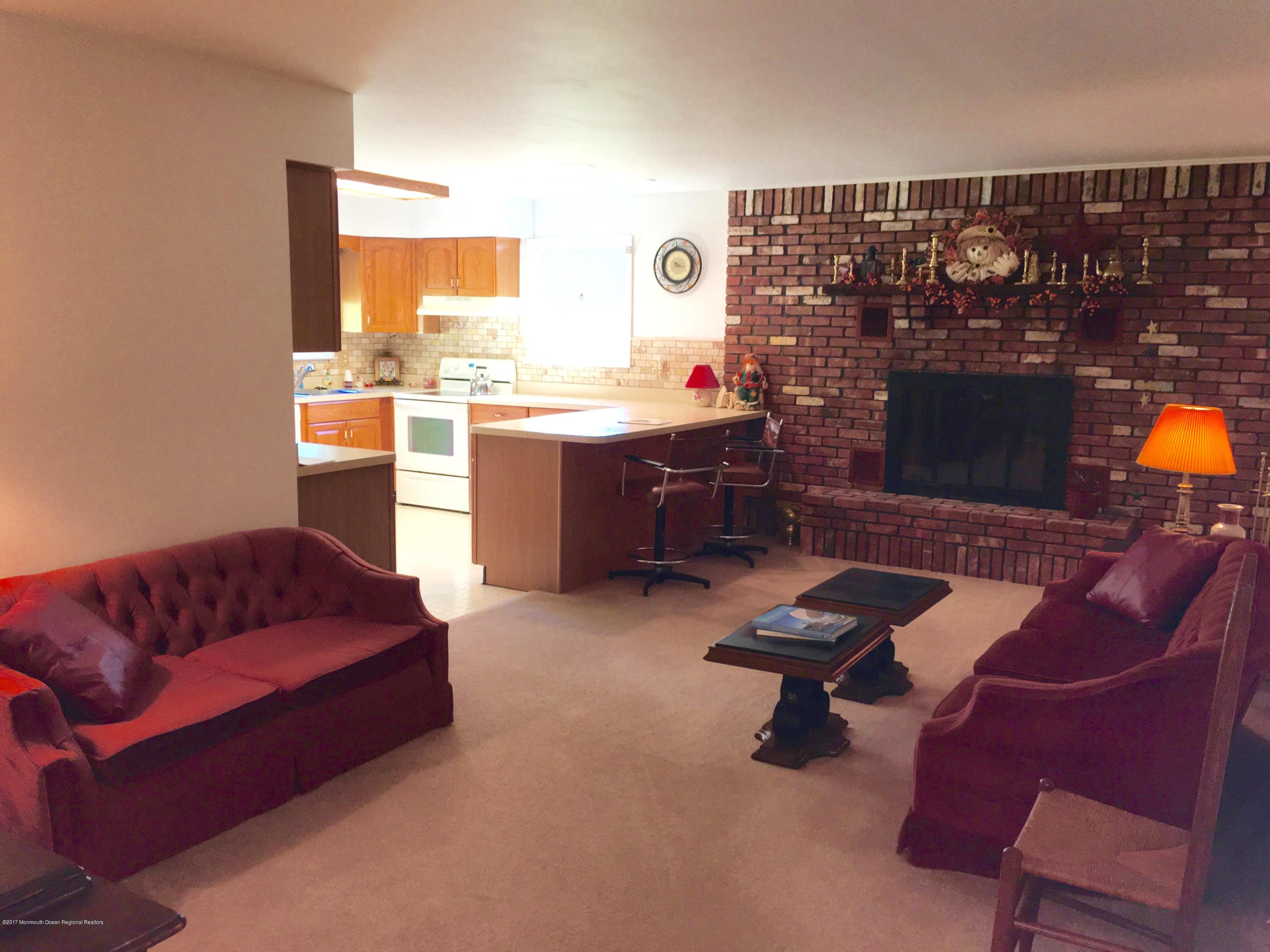 10 Fenimore Road Freehold, NJ 07728 - Photo 4 of 36 a living room with furniture and a fireplace