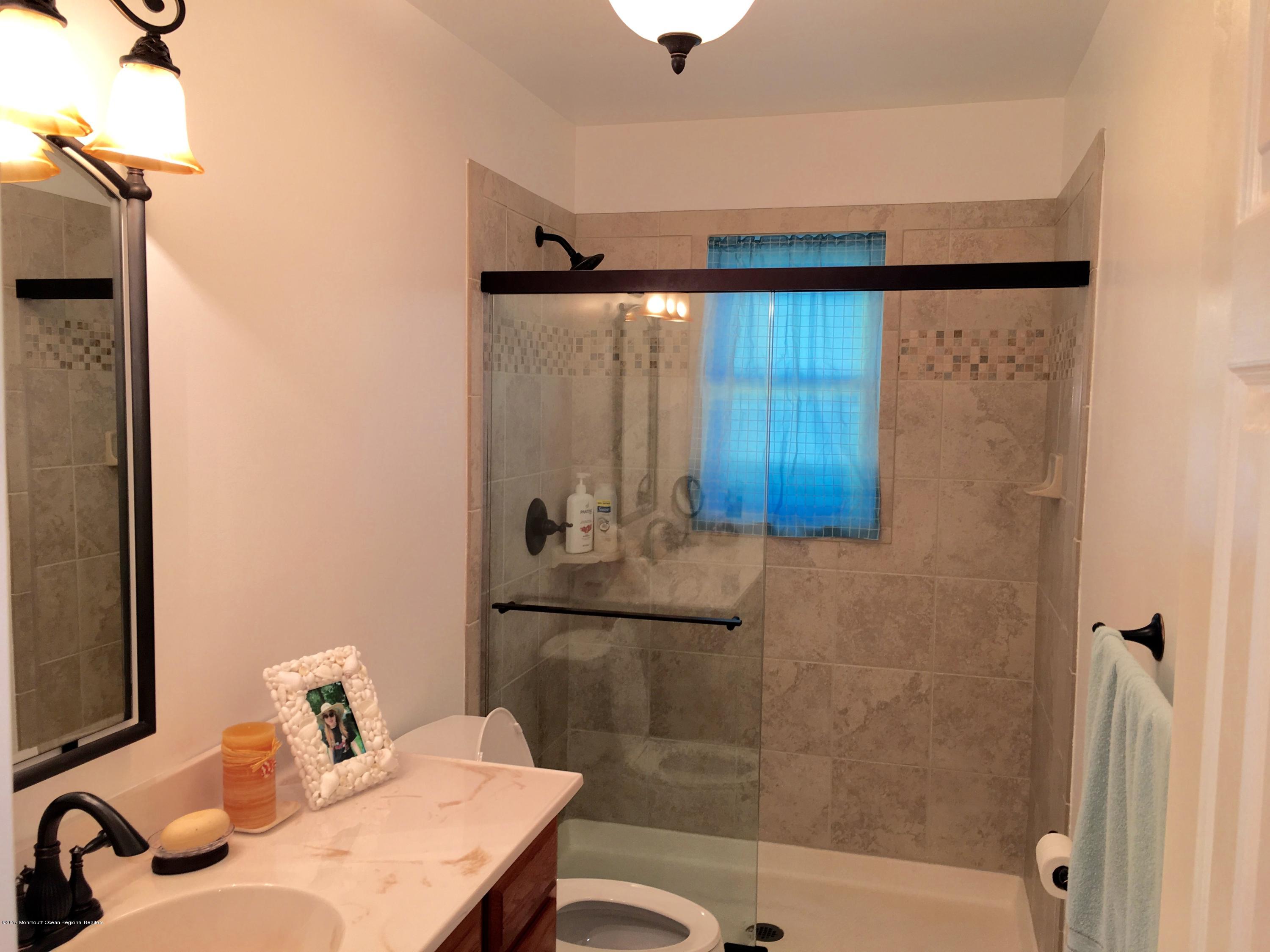 10 Fenimore Road Freehold, NJ 07728 - Photo 5 of 36 a bathroom with a sink and a mirror
