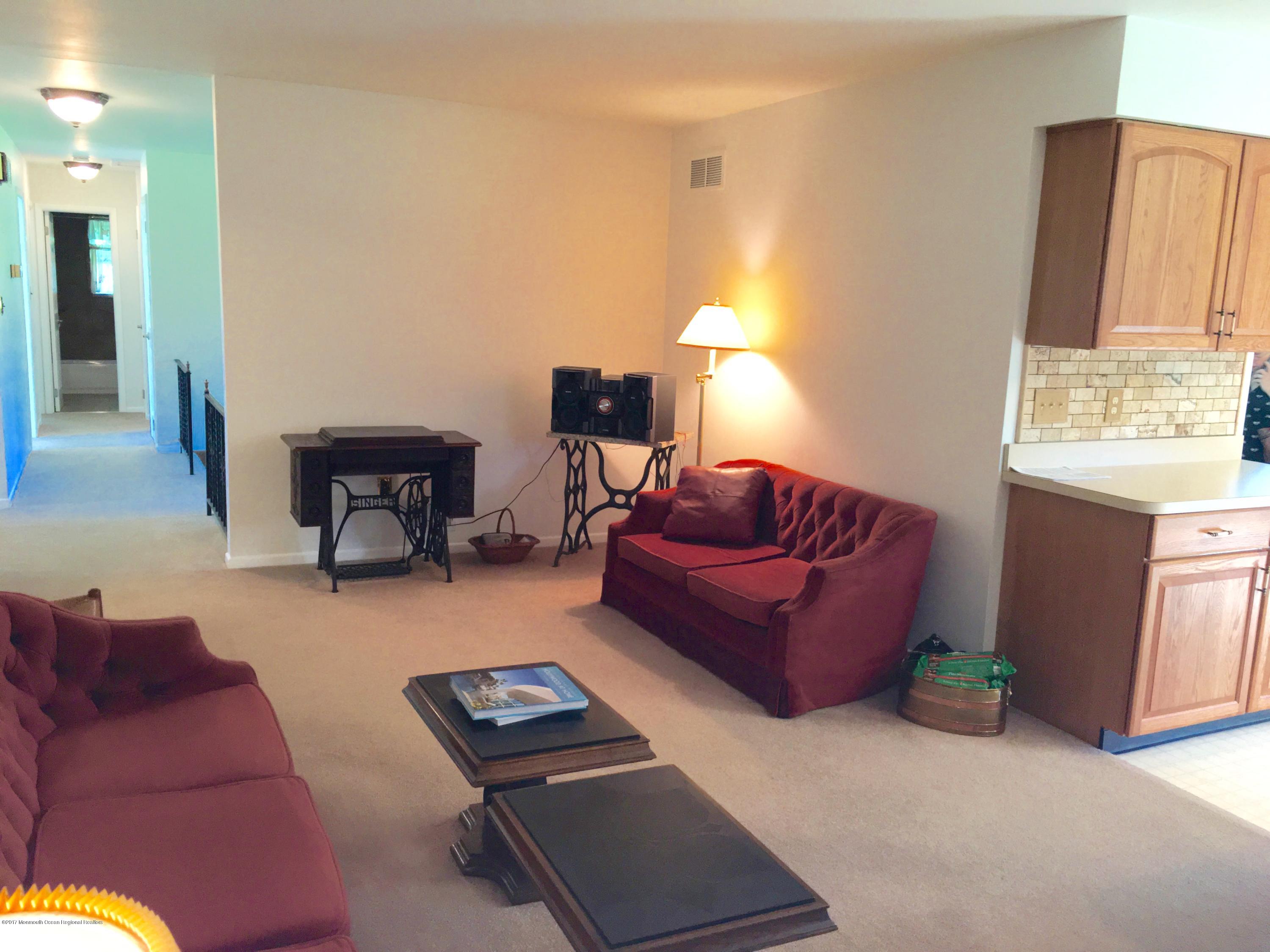 10 Fenimore Road Freehold, NJ 07728 - Photo 6 of 36 a living room with furniture and a fireplace