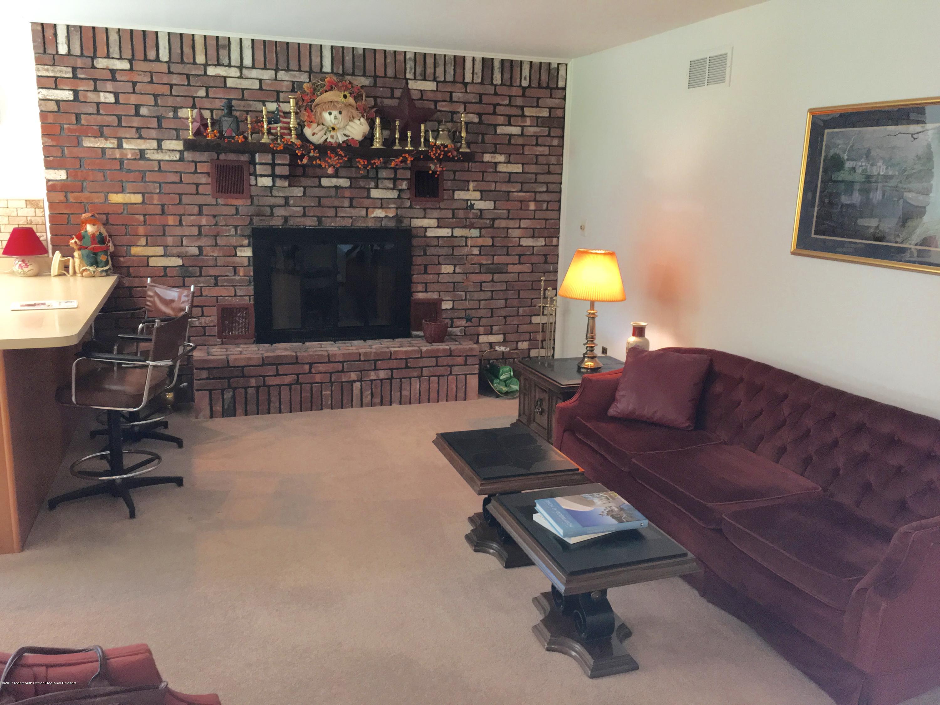 10 Fenimore Road Freehold, NJ 07728 - Photo 7 of 36 a living room with furniture and a fireplace