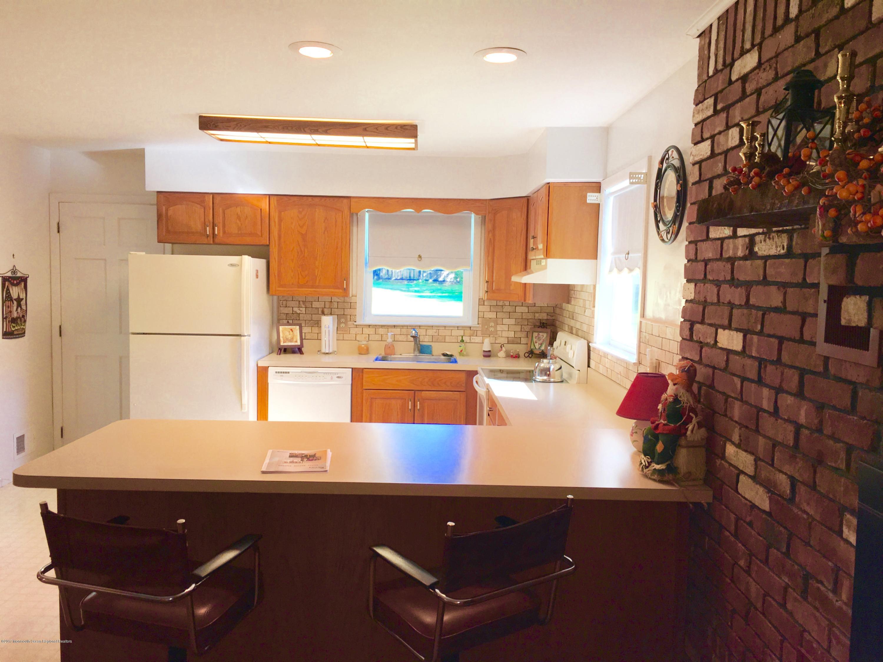 10 Fenimore Road Freehold, NJ 07728 - Photo 8 of 36 a room with a table chairs and a painting on the wall