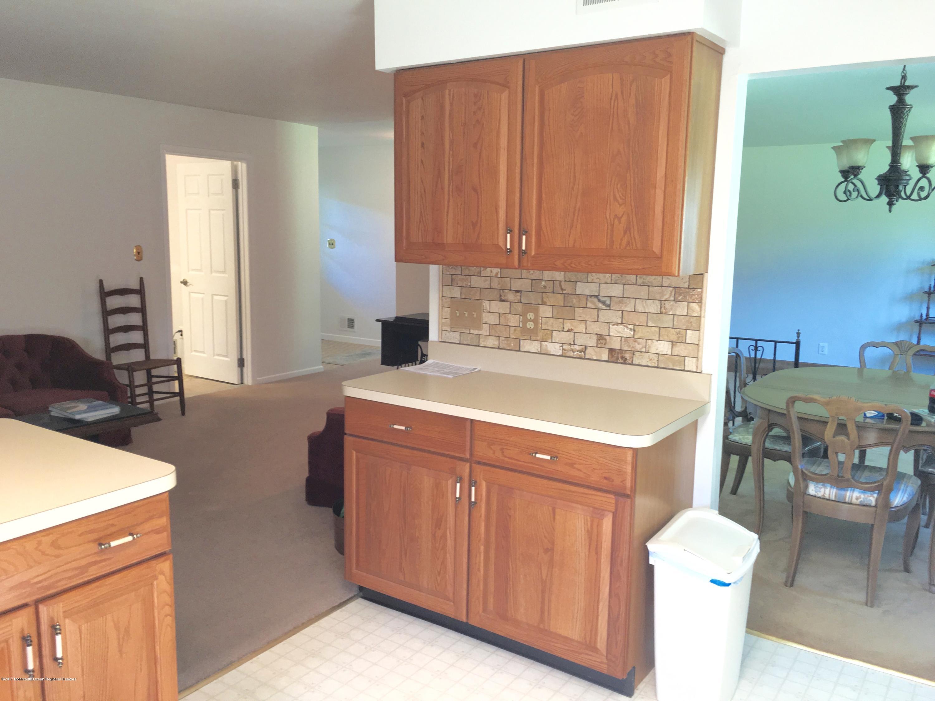 10 Fenimore Road Freehold, NJ 07728 - Photo 9 of 36 a kitchen with a sink cabinets and wooden floor