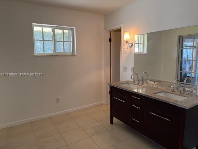 29325 Southwest 182nd Avenue Homestead, FL 33030 - Photo 11 of 21 a bathroom with a double vanity sink and mirror