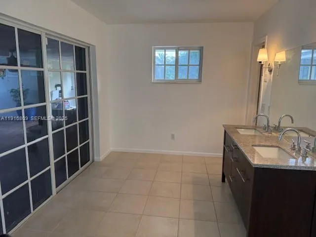 a bathroom with a double vanity sink and a mirror