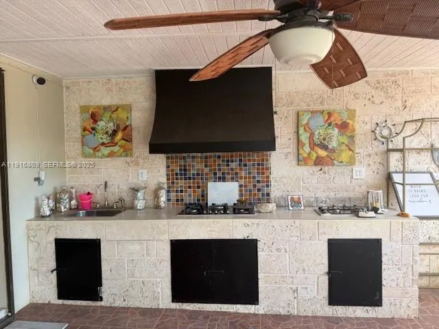 a kitchen with stainless steel appliances kitchen island granite countertop a sink and a microwave