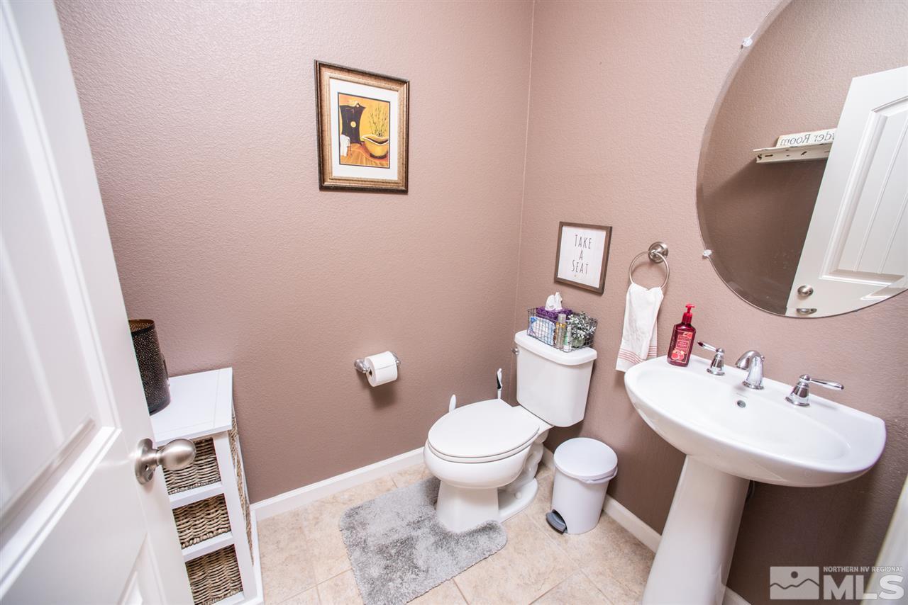 1930 Tawleed Road Reno, NV 89521 - Photo 20 of 28 a bathroom with a toilet a sink and a mirror