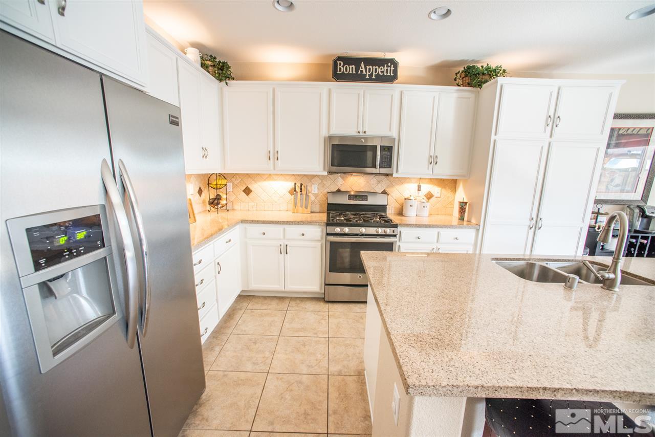 1930 Tawleed Road Reno, NV 89521 - Photo 7 of 28 a kitchen with stainless steel appliances granite countertop a refrigerator a stove and a sink