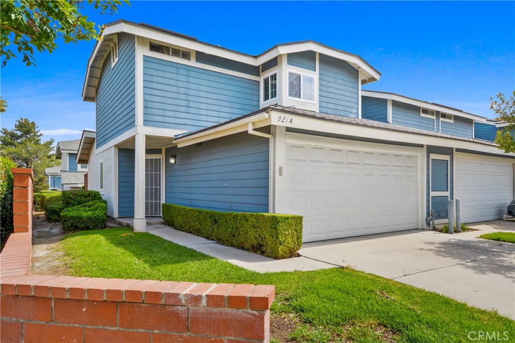 921 Boon Place, Unit A Corona, CA 92881 - Photo 1 of 21 a front view of a house with a yard and garage