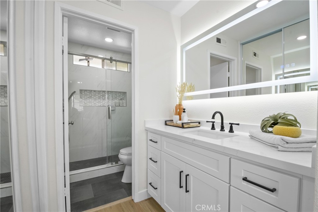 921 Boon Place, Unit A Corona, CA 92881 - Photo 12 of 21 a bathroom with a granite countertop sink and a mirror