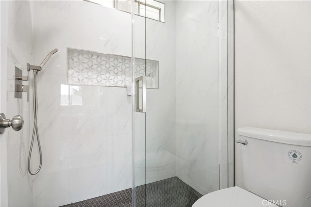 921 Boon Place, Unit A Corona, CA 92881 - Photo 14 of 21 a bathroom with a granite countertop shower and a toilet