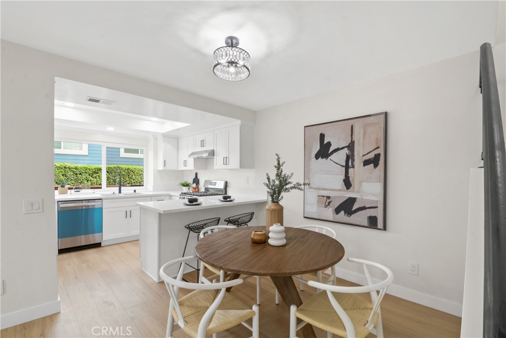 921 Boon Place, Unit A Corona, CA 92881 - Photo 6 of 21 a view of a dining room with furniture and wooden floor