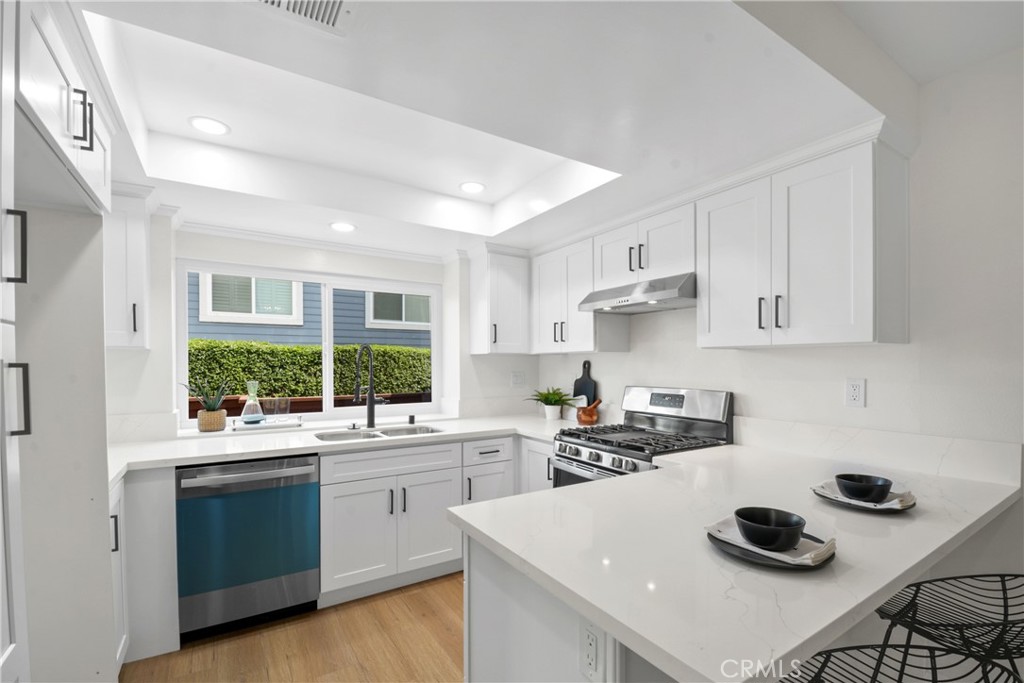 921 Boon Place, Unit A Corona, CA 92881 - Photo 7 of 21 a kitchen with a sink stove and cabinets