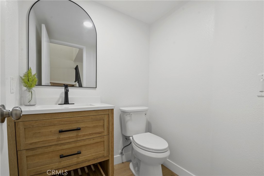 921 Boon Place, Unit A Corona, CA 92881 - Photo 8 of 21 a bathroom with a toilet a sink and mirror