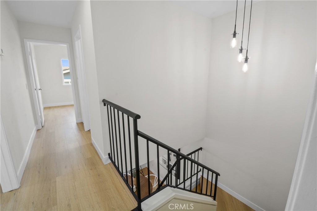 921 Boon Place, Unit A Corona, CA 92881 - Photo 9 of 21 a view of a hallway with wooden floor and entryway