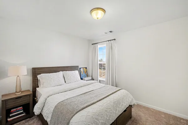 a bedroom with a bed and a window