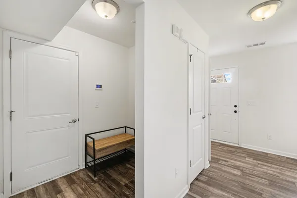 a view of a room with wooden floor