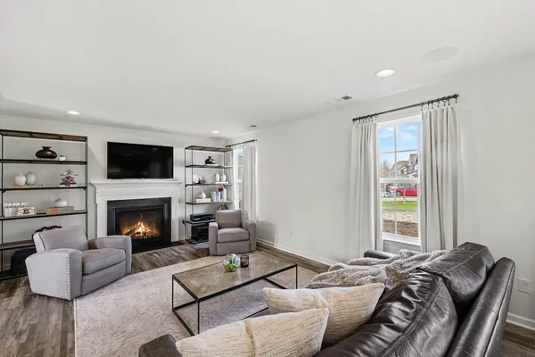 a living room with furniture fireplace and window