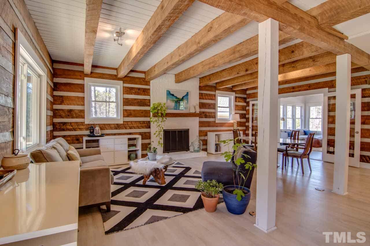 2704 Mt Vernon Church Road Raleigh, NC 27613 - Photo 2 of 23 a living room with furniture a fireplace and a floor to ceiling window