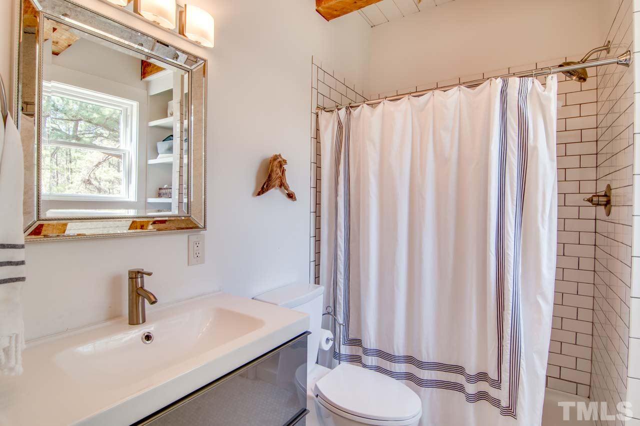 2704 Mt Vernon Church Road Raleigh, NC 27613 - Photo 11 of 23 a bathroom with a sink a toilet and shower curtain