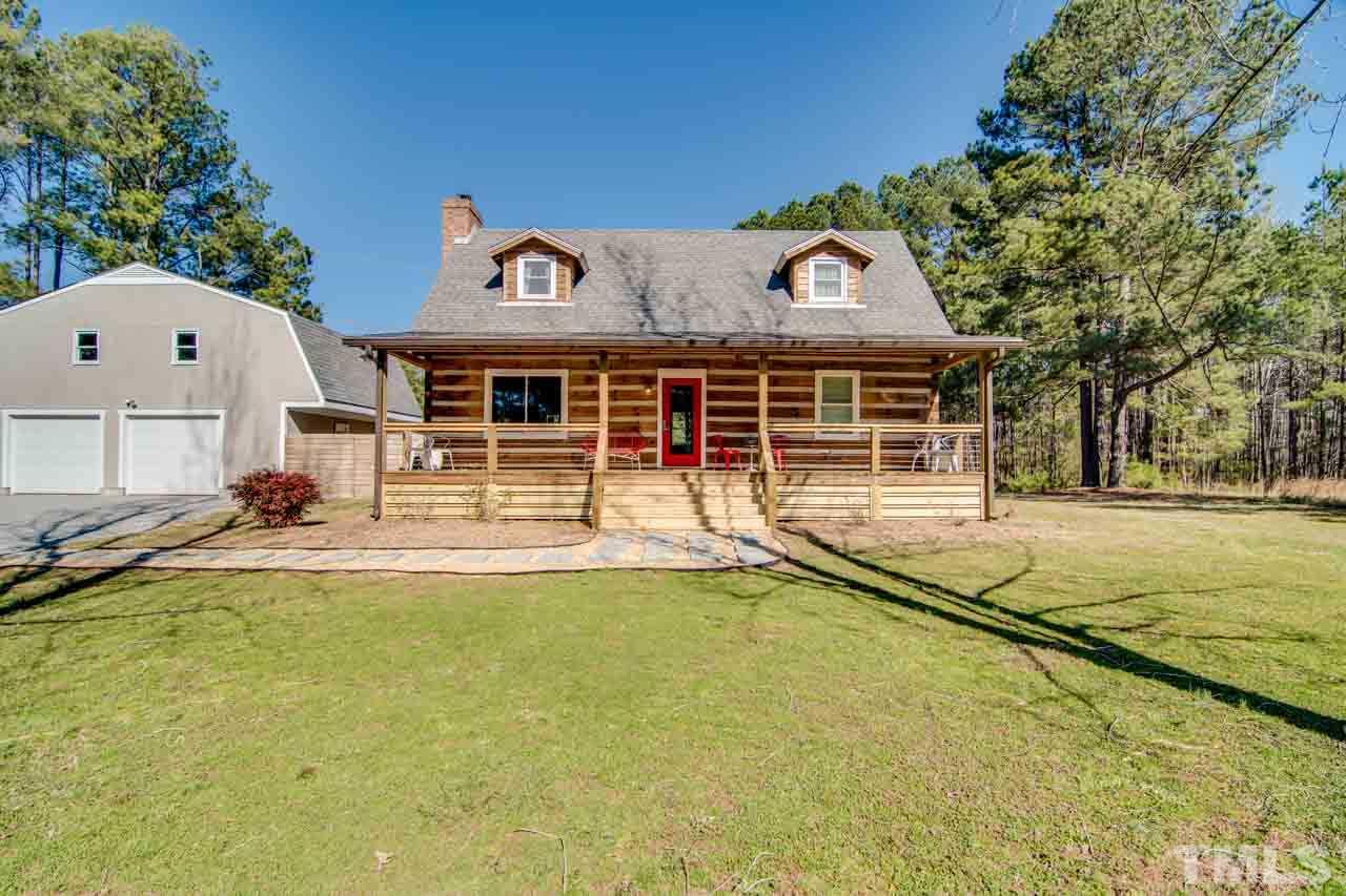 2704 Mt Vernon Church Road Raleigh, NC 27613 - Photo 18 of 23 a view of a house with large windows and a small yard