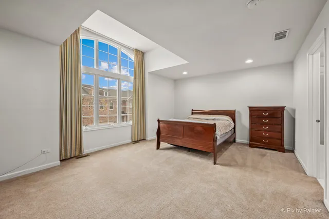 a bedroom with bed and window