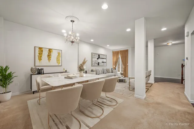 a room with stainless steel appliances kitchen island granite countertop a sink and cabinets